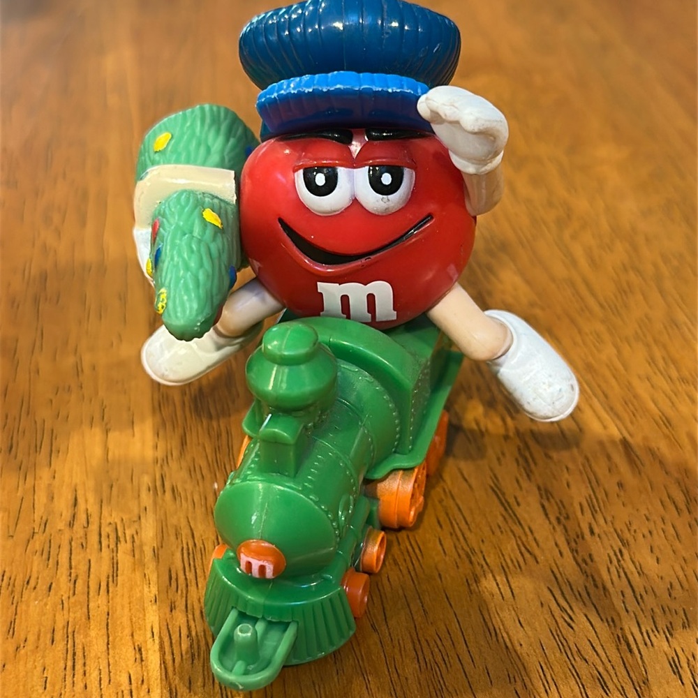 M&M's Red with blue hat on a green train. Candy topper.